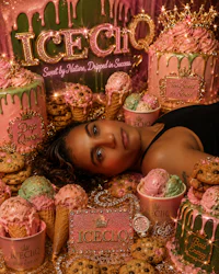 a woman laying on top of ice cream and cupcakes